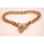 A 9ct gold curblink bracelet with heart shaped padlock clasp and safety chain, each link stamped 9
