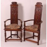 A pair of medieval style oak elbow chairs, each of triform with blind carved panel backsCondition