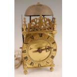 A Victorian brass lantern clock, having a fret-cut gallery over brass Roman chapter ring, single