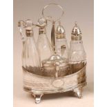 A George III silver five-bottle cruet, of oval form, with bright cut engraved decoration, comprising