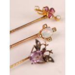 Three stick pins: A yellow metal pin as a winged insect with an oval amethyst abdomen and a 1.3mm