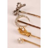 A yellow metal and diamond set stick pin, the old cut claw set diamond weighing approx 0.25