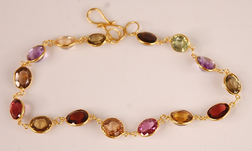 A contemporary yellow metal multi-stone bracelet, featuring 15 round and oval cut amethyst, citrine,