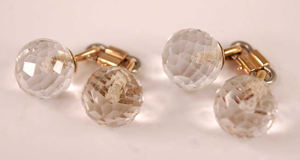 A pair of yellow and white metal double-ended cufflinks, each with two 21mm diameter faceted rock