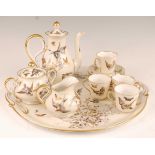 A circa 1900 continental porcelain part coffee service on cabaret tray, comprising coffee pot,