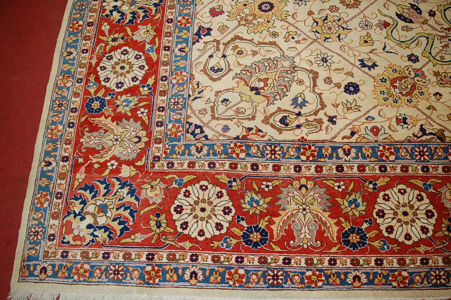 A Persian woollen cream ground carpet, decorated with scroll flowers and foliage within trailing - Image 4 of 24