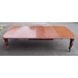 A Victorian mahogany extending dining table, of good size, the top having double wind-out action,
