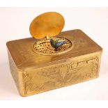 A circa 1900 French gilt brass musical automata box, the engraved oval hinged lid opening to
