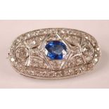 A white metal Art Deco style sapphire and diamond lozenge shaped panel brooch, featuring a centre