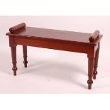 A mahogany window seat, in the Victorian style, having turned ends and on ring turned tapering