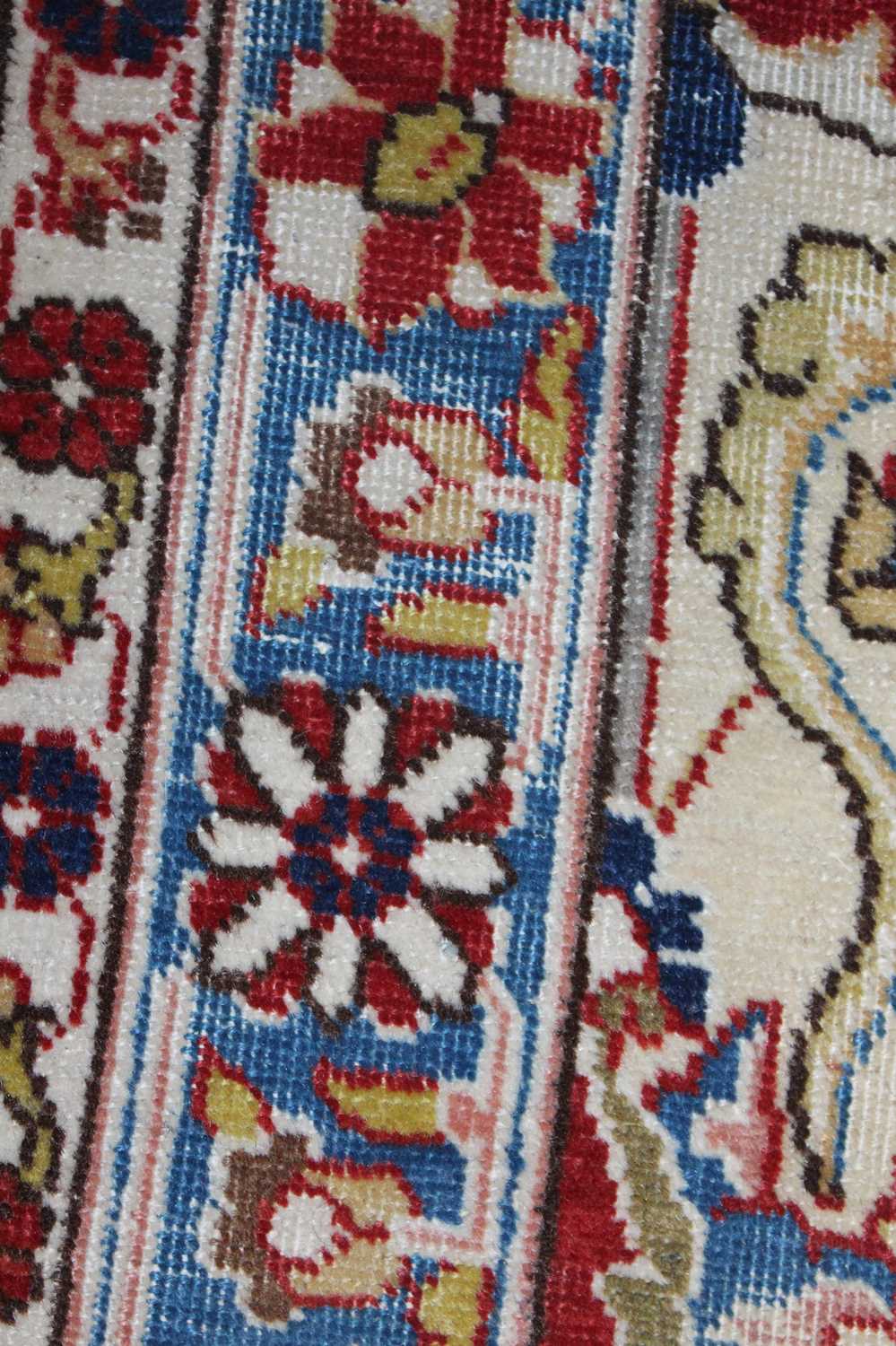 A Persian woollen cream ground carpet, decorated with scroll flowers and foliage within trailing - Image 18 of 24