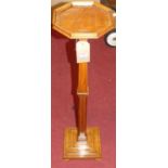 A late Victorian satinwood pedestal torchiere, having fixed octagonal top, all raised on a stepped