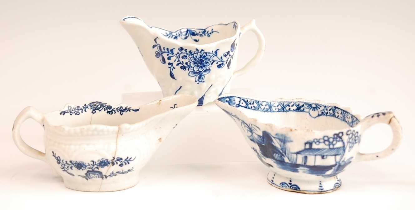 A Lowestoft porcelain cream boat, having a moulded body, underglaze blue decorated with floral