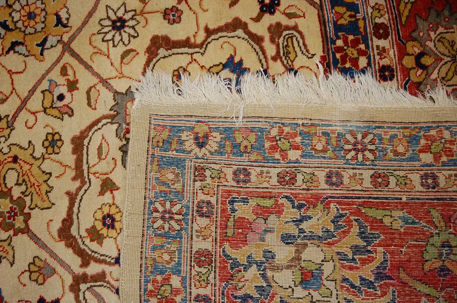 A Persian woollen cream ground carpet, decorated with scroll flowers and foliage within trailing - Image 12 of 24