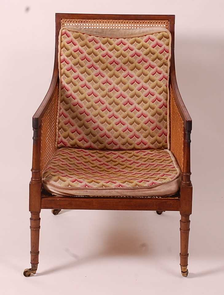A 19th century mahogany Bergere library chair, having split cane back, side and seat, raised on ring - Image 3 of 10