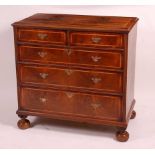 An 18th century and recently re-veneered walnut chest, having a crossbanded top over two short and