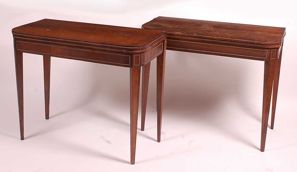 A pair of Regency rosewood D-shaped card tables, each with fold-over tops opening to reveal baize