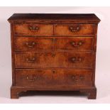 A George II oak and walnut fronted chest, of two short and three long crossbanded and graduated