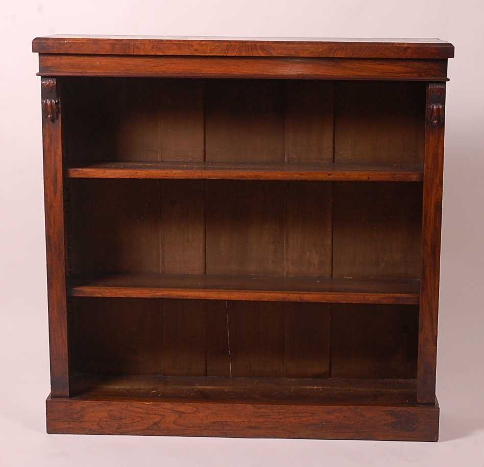 A Victorian walnut freestanding open bookshelf, having moulded pilasters and raised upon a plinth,
