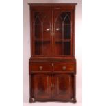 A Regency mahogany secretaire bookcase, having twin gothic arched glazed doors with enclosed