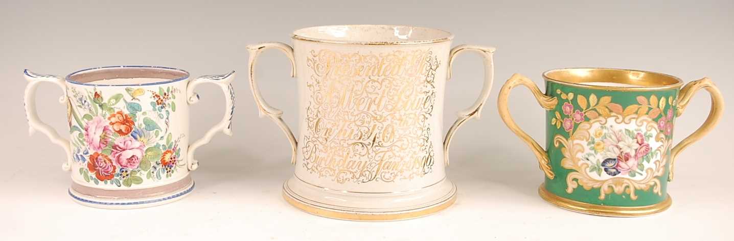 A Victorian soft-paste porcelain loving cup, enamel decorated with a floral reserve within gilt - Image 2 of 2