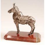 An early 20th century continental white metal model of a donkey, in standing pose and full livery,