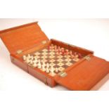 A circa 1900 mahogany travelling chess set, having fold-out action opening to reveal rosewood and