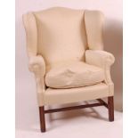 A mahogany framed wingback armchair, in the Georgian style, the whole recently reupholstered in a