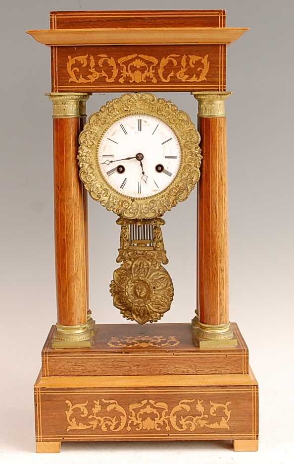 A late 19th century French rosewood and marquetry inlaid portico clock, the unsigned white enamel