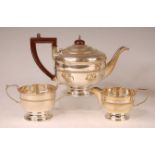 A George V silver three-piece tea set, comprising teapot, twin handled sugar and cream, each of