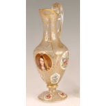 A 19th century Bohemian overlaid glass pedestal ewer, the panels polychrome decorated with
