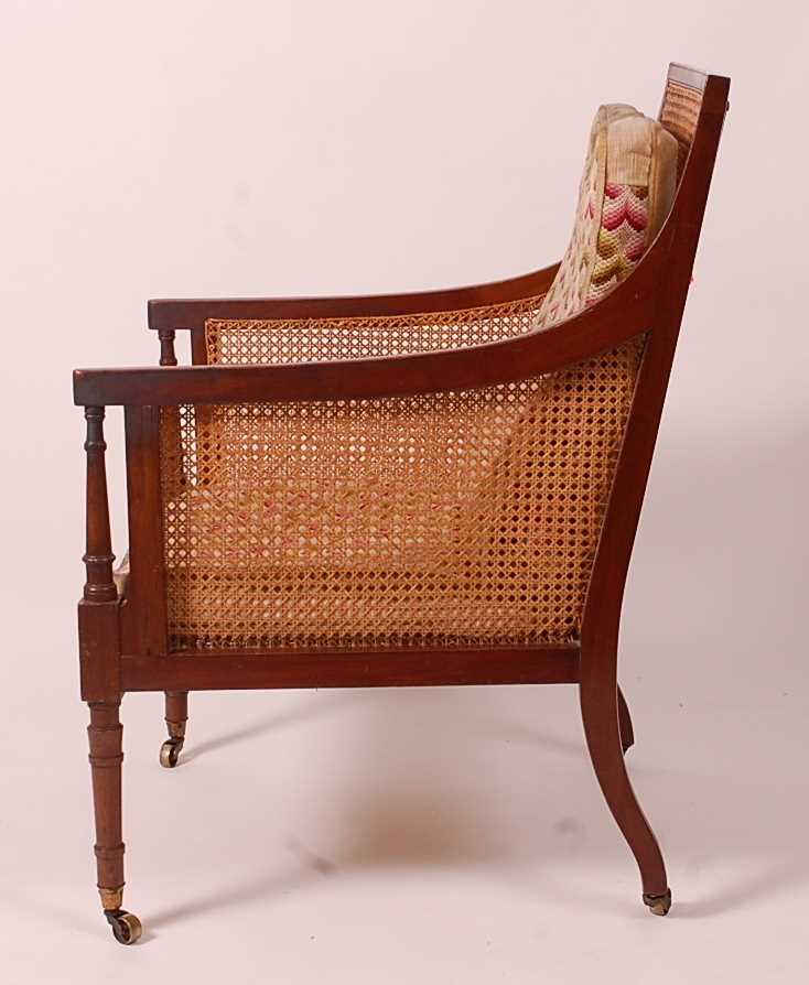 A 19th century mahogany Bergere library chair, having split cane back, side and seat, raised on ring - Image 4 of 10