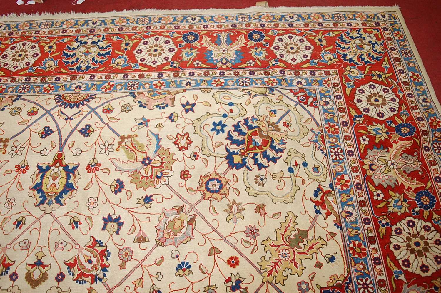 A Persian woollen cream ground carpet, decorated with scroll flowers and foliage within trailing - Image 11 of 24