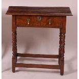 An 18th century joined elm single drawer side table, having a two-plank top, w.67cm, d.39cm, h.