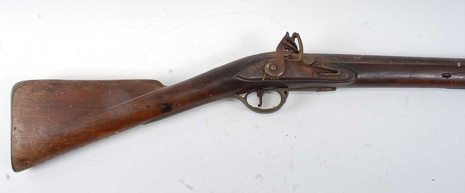 An early 19th century flintlock rifle, having a 101cm barrel, unmarked lock and brass mounted walnut