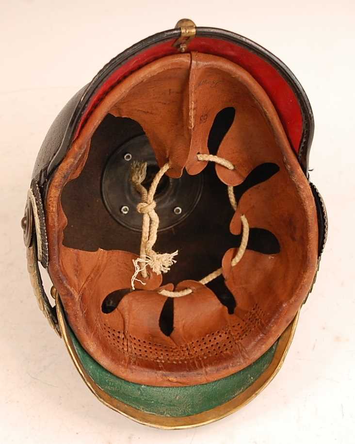 A Prussian pickelhaube, the leather skull with brass ball top and eagle plate, flanked by state - Image 7 of 9