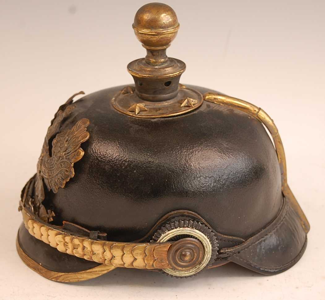 A Prussian pickelhaube, the leather skull with brass ball top and eagle plate, flanked by state - Image 3 of 9