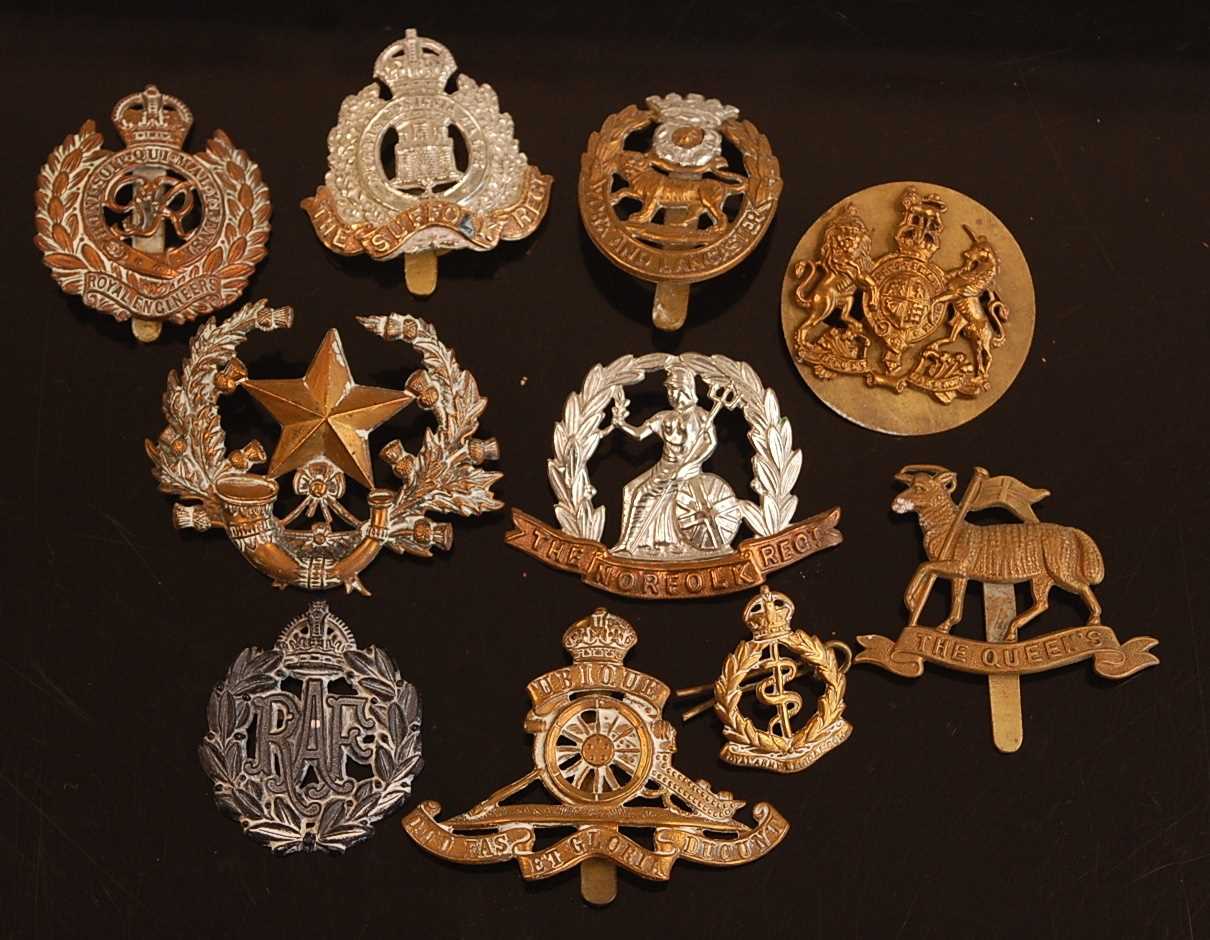 A collection of cap badges and buttons to include Suffolk Regiment, Norfolk Regiment, York and