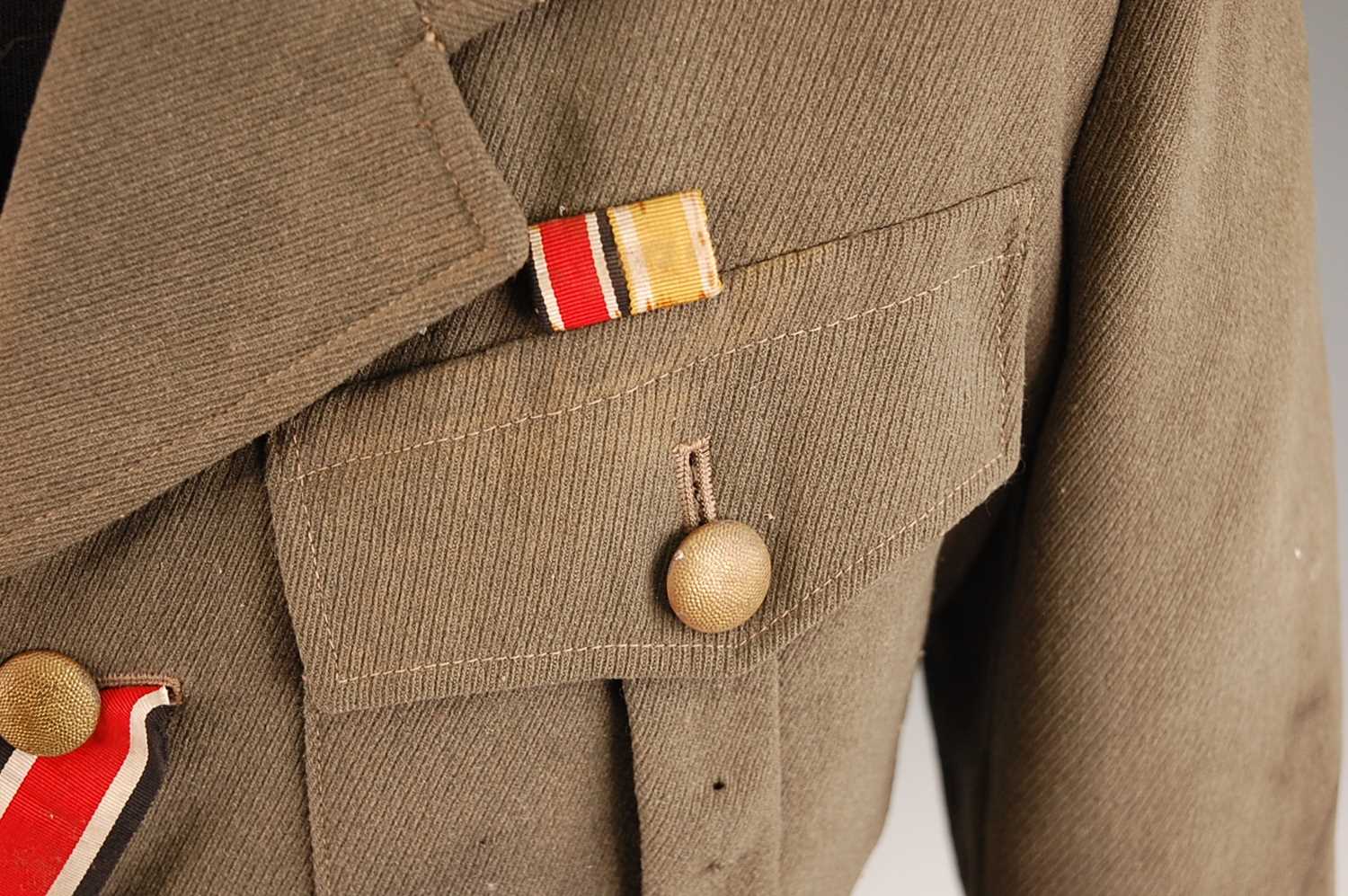 A German Army tunic, in green having four pleated pockets with pebble effect buttons and War Service - Image 2 of 14