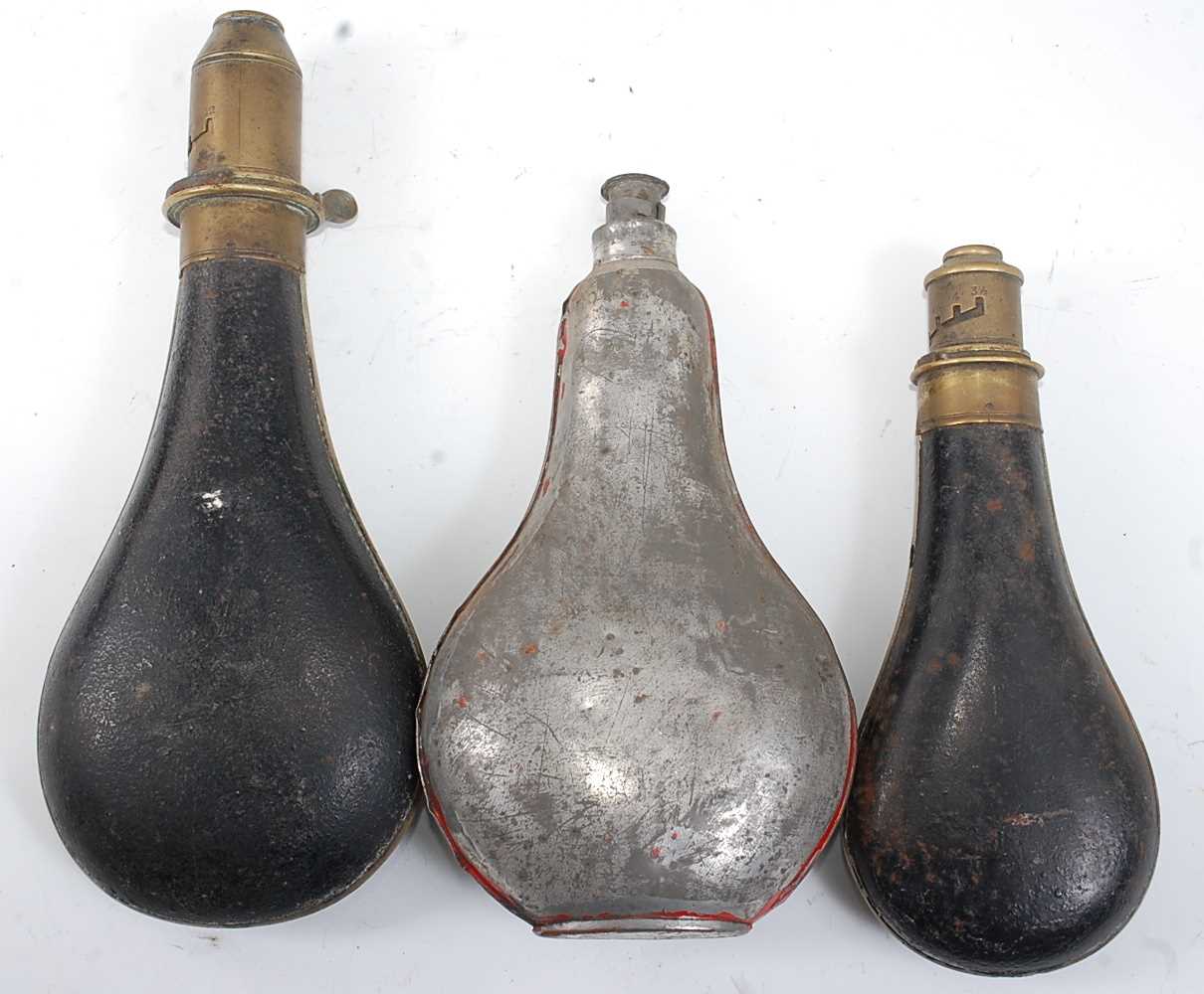 A late 19th century black painted metal powder flask of typical bag shape, the brass nozzle - Image 2 of 2