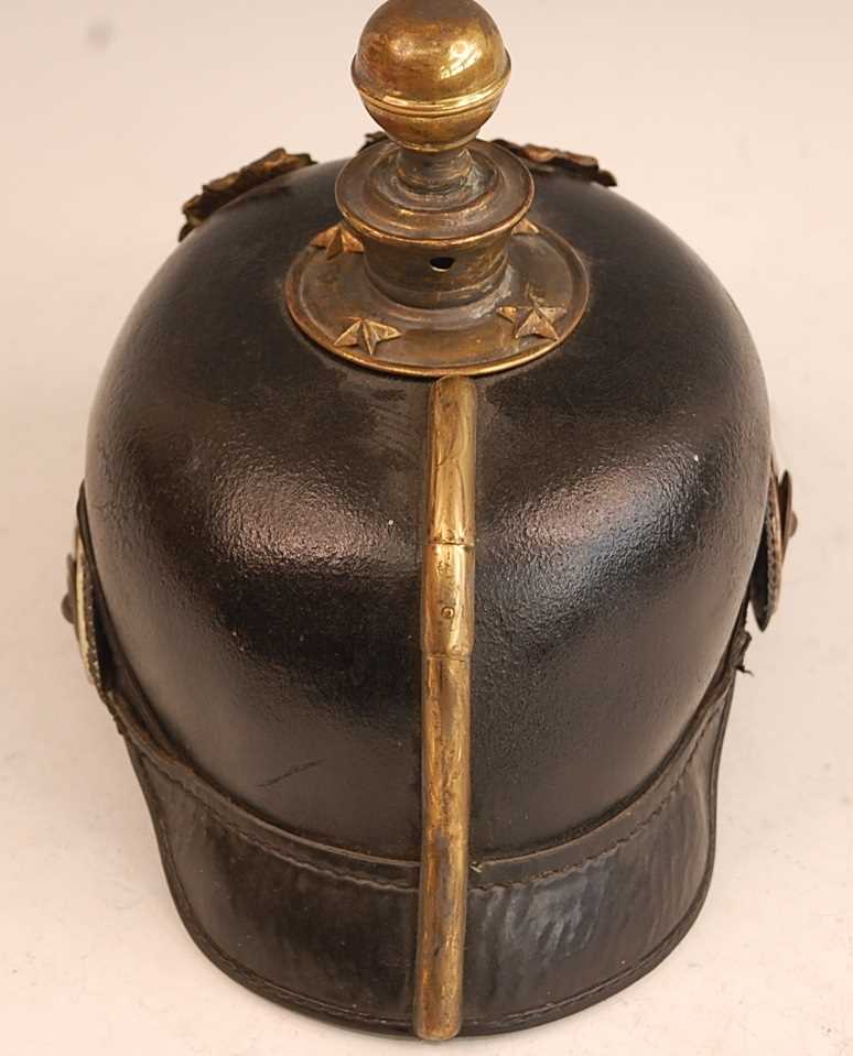 A Prussian pickelhaube, the leather skull with brass ball top and eagle plate, flanked by state - Image 5 of 9