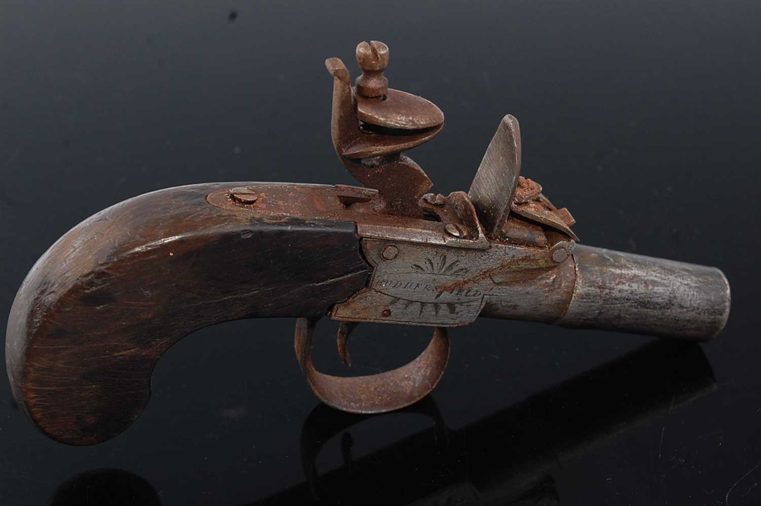 A 19th century flintlock box-lock pocket pistol, having a 4cm turn-off steel barrel, the lock signed