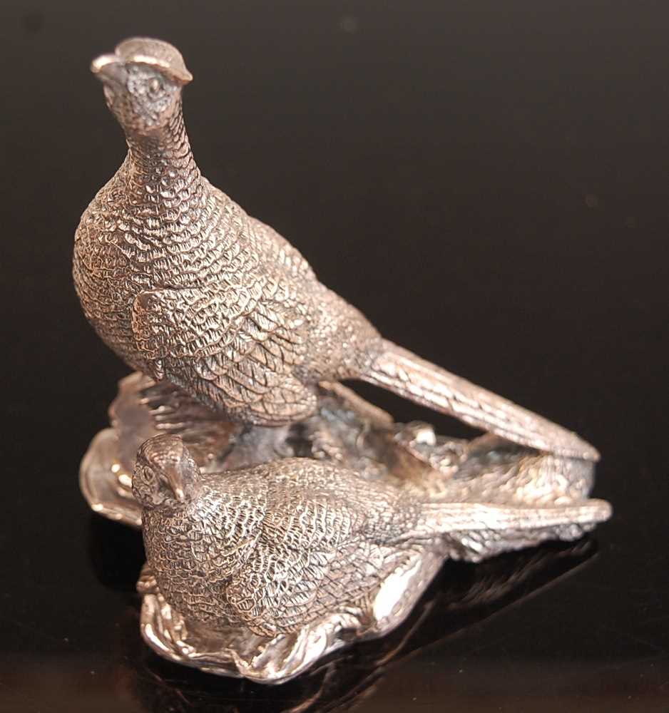 A comtemporary filled silver table ornament in the form of a cock and hen pheasant, maker Camelot