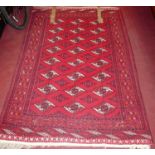 A Persian woollen red ground Bokhara rug, 188 x 131cm