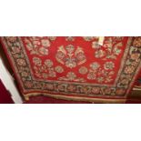 A Persian style machine woven red ground Tabriz type rug
