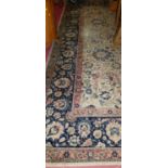 A large Benlian cream ground Tabriz rug, with small Benlian label to underside of one corner, 410