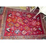 A Persian woollen red ground Bokhara rug, 174 x 124cm
