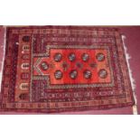 A Persian woollen red ground Bokhara prayer rug, 115 x 82cm
