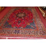 A large Persian woollen red ground Tabriz rug, 390 x 295cmCondition report: Generally in good