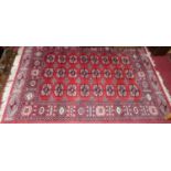 A Persian style machine woven red ground Bokhara rug, 180 x 122cm
